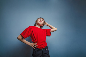 Boy, teenager, twelve years in  red shirt, thoughtful, derzhet h