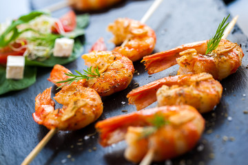 Roasted shrimp starter on skewer.