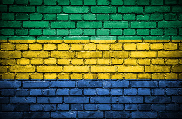 Brick wall with painted flag of Gabon