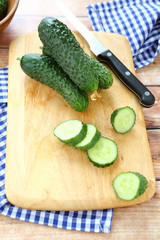 Fresh cucumbers on the board