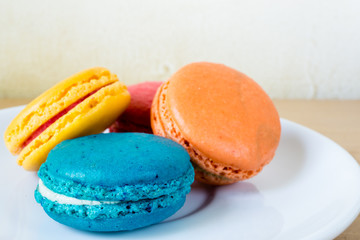 French macaroons on plate, with vintage pastel
