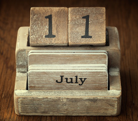 A very old wooden vintage calendar showing the date 11th July on