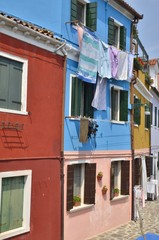 Fototapeta na wymiar Laundry on blue house in Burano, Venice, Italy