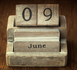 A very old wooden vintage calendar showing the date 9th June on