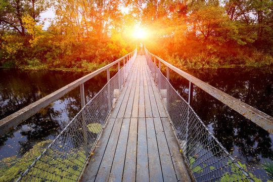 Fototapeta Small bridge over river in forest
