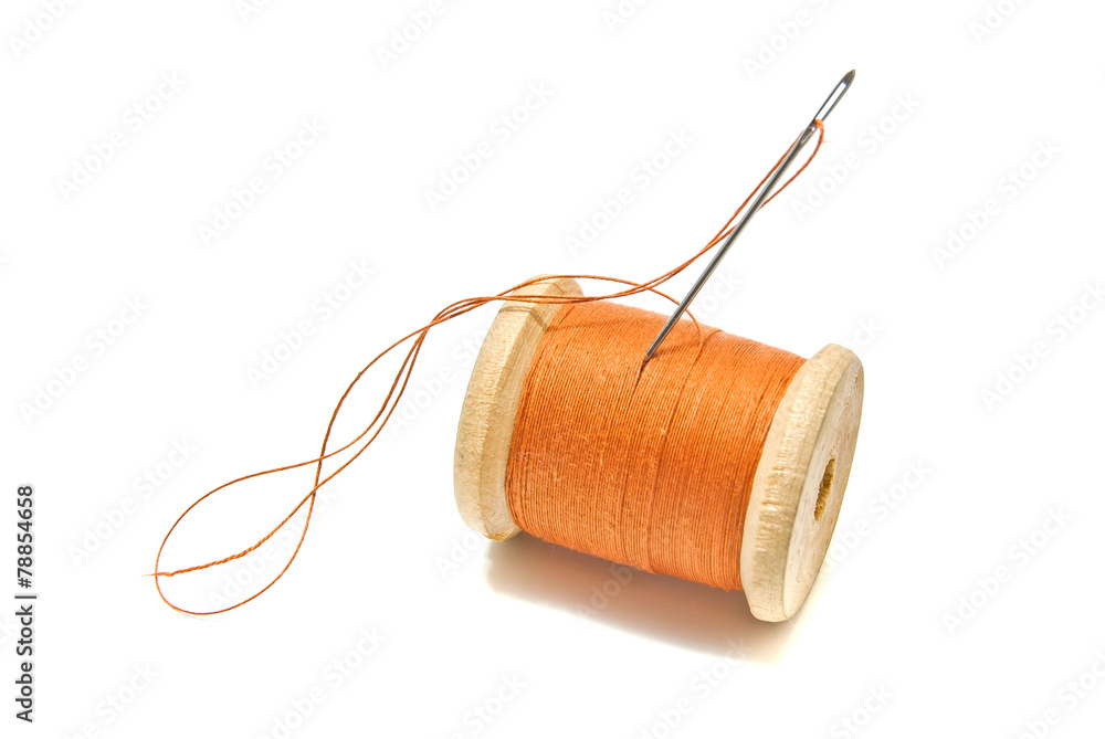 Wall mural spool of orange thread and needle