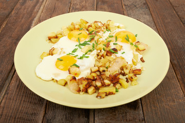 Fried potatoes with eggs on the table