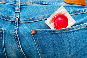 Red condom in jeans back pocket