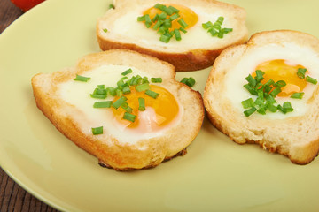 Fototapeta na wymiar Fried eggs in a plate on the table