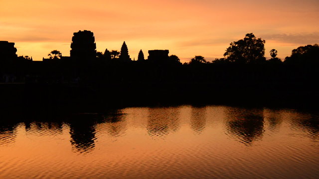 Zoom out - Silhouette of the Main Temple Buildings with Lake Reflection at Sunrise - Angkor Wat, Cambodia