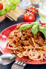Spaghetti bolognese with cheese and basil