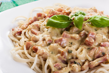 Spaghetti carbonara with bacon and basil