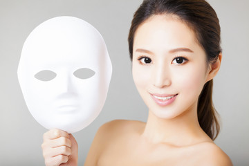 young woman holding white mask for medical beauty concept