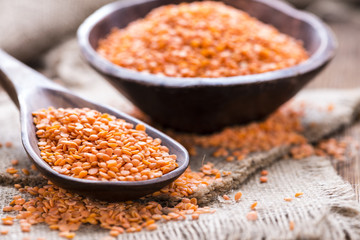 Red Lentils on a wooden spoon - obrazy, fototapety, plakaty