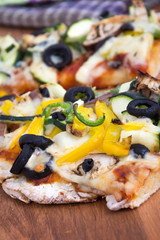 vegetable homemade rustic pizza closeup on wood table
