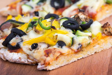 vegetable homemade rustic pizza closeup on wood table