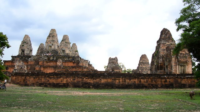 Zoom Out - Stone Wall with Temple Remains in the Background - Angkor Wat Temple Cambodia