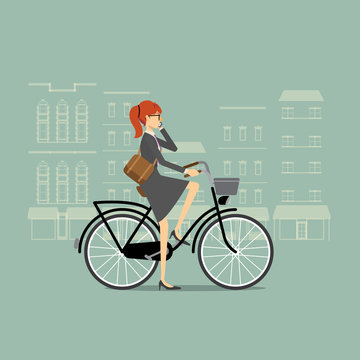 Business woman on a bicycle talking on the phone