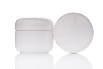 close up of beauty cream container on white background