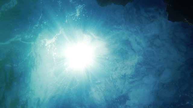 Underwater camera background: sun rays visible from the bottom