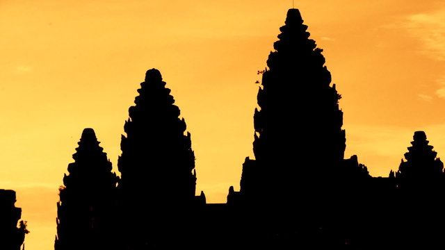 Zoom out of Silhouettes of Main Temple Spires at Sunrise - Angkor Wat, Cambodia