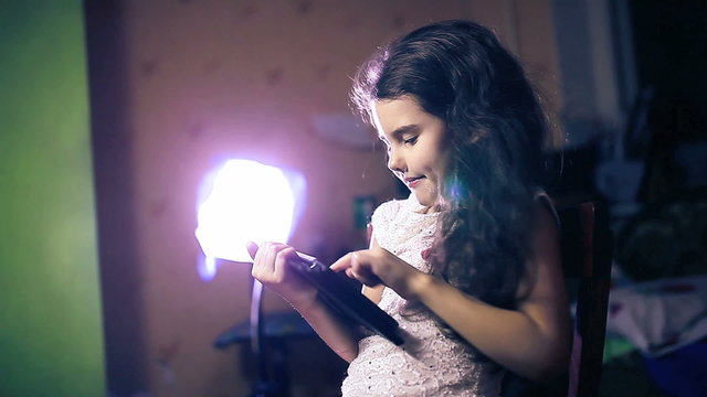 teen girl playing  in room  in evening tablet brunette six years