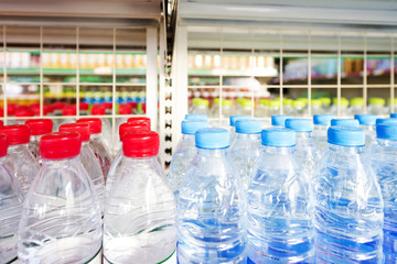 Many bottles of clean water with blue and red lids