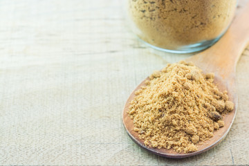 brown  sugar with wooden Ladle on Wooden background.