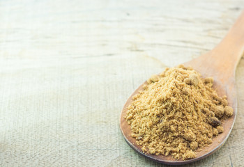 brown  sugar with wooden Ladle on Wooden background.