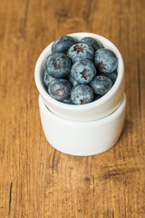 Blueberries in a bowl on a wooden table