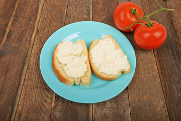 Sandwiches with cream cheese on a wooden table