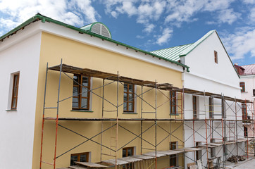 Fototapeta na wymiar Old building facade under reconstruction