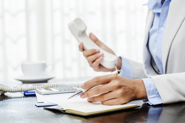 Businesswoman working in office on her desk
