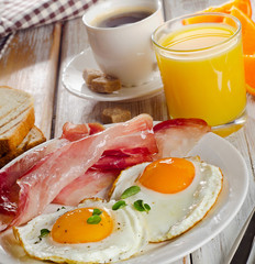 Fototapeta premium Coffee , Two eggs and bacon for healthy breakfast