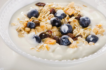 Healthy breakfast - yogurt with blueberries and muesli served in