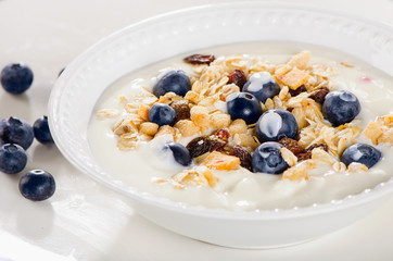 Healthy breakfast - yogurt with fresh blueberries and muesli