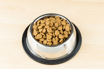 Dog Kibbles in a bowl on wooden floor