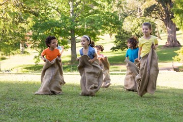 Children having a sack race in park