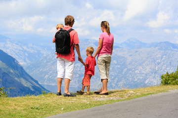 family with kids hiking in mountains