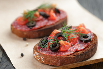 open rye sandwich with salami and vegetables