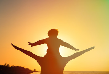 father and son having fun on sunset