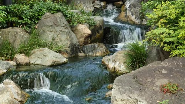 Waterfall runs into a Koi pond at Sensoji Temple Tokyo Japan