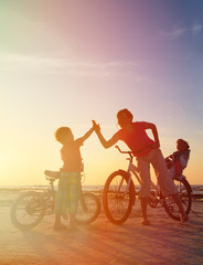 Obraz na płótnie Canvas Biker family silhouette at sunset
