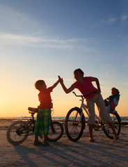 Biker family silhouette at sunset