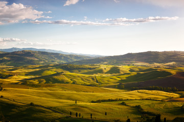 hills lit with morning sun, rural landscape in Tuscany