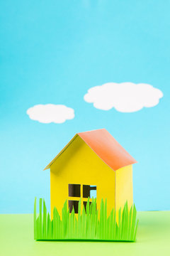 Paper yellow  house against the blue sky
