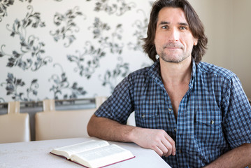 man reads a book at the table