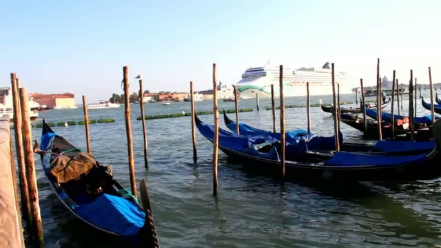 Gondolas at rest by Piazza San Marco and cruise ship