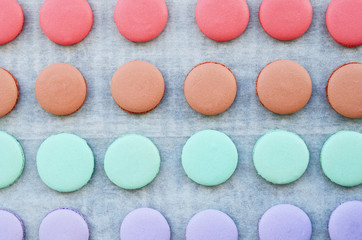 Lavender, mint, caramel and pink macaroon cups over baking paper