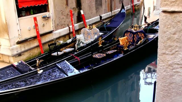 Two old  gondolas in the small canal of Venice